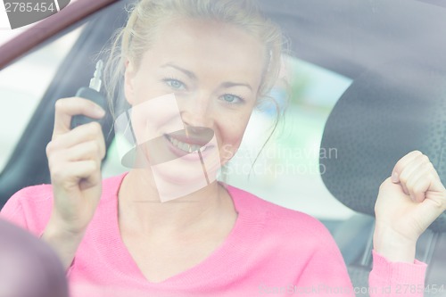 Image of Woman driver showing car keys.