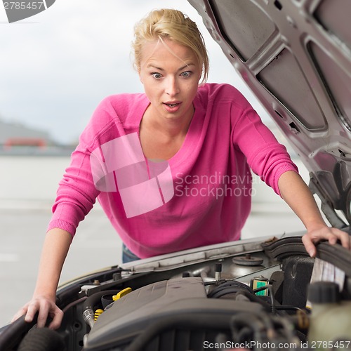 Image of Stressed Young Woman with Car Defect.