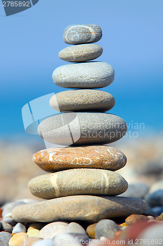 Image of Stones over blue sky and sea