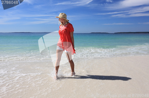 Image of Happy woman splashing feet at the beach