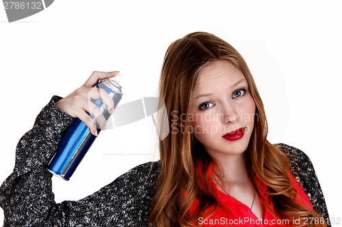 Image of Girl putting hairspray on.