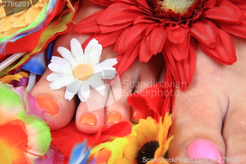 Image of women feets and flowers (pedicure tbackground)