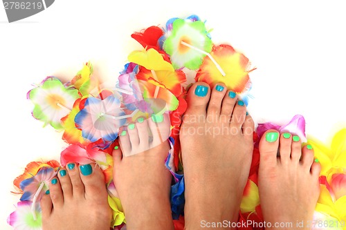 Image of women feets and flowers (pedicure tbackground)