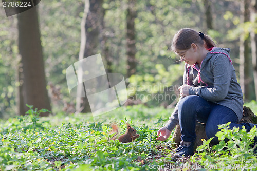 Image of Little girl and squirrel