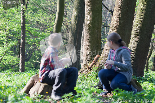 Image of Squirrel and two children at park