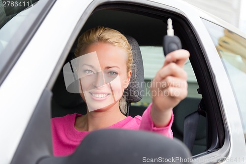 Image of Woman driver showing car keys.