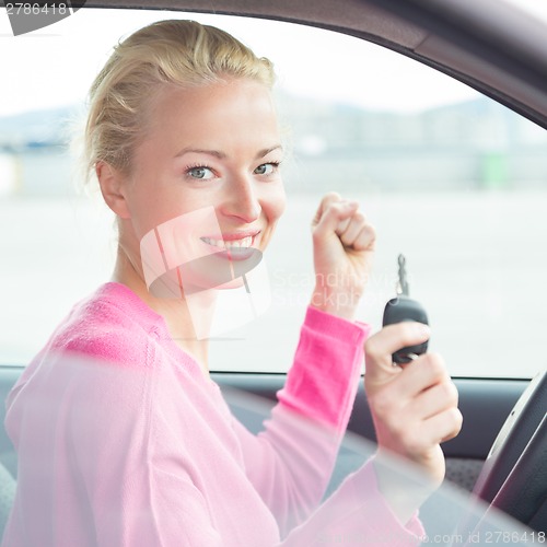 Image of Woman driver showing car keys.