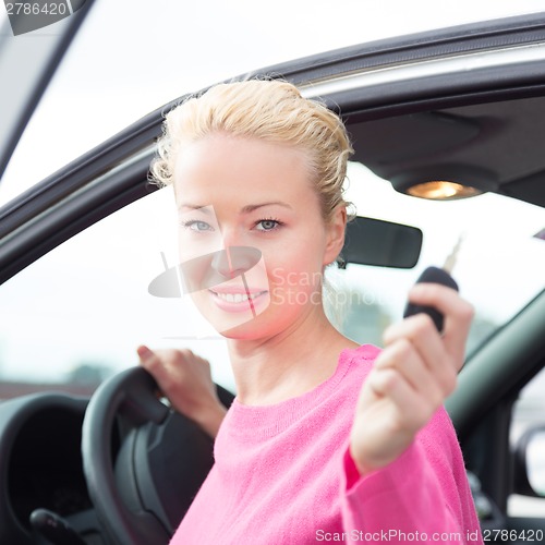 Image of Woman driver showing car keys.