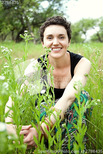 Image of girl resting on fresh spring grass 