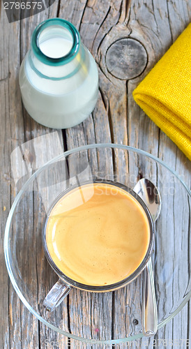 Image of Cup of coffee on a wooden table