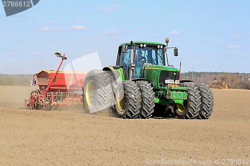 Image of Farmer Working the Field with John Deere Tractor and Seeder