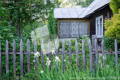 Image of old country house with porch and rustic wood fence 