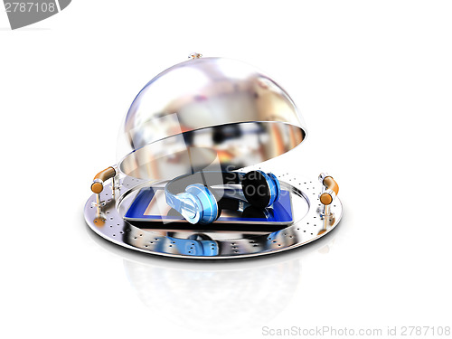 Image of Phone and headphones on glossy salver dish under a cover 