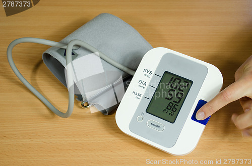 Image of measuring blood pressure finger on start button