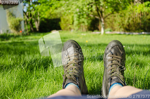 Image of close up of women sneakers climbing fine grass 