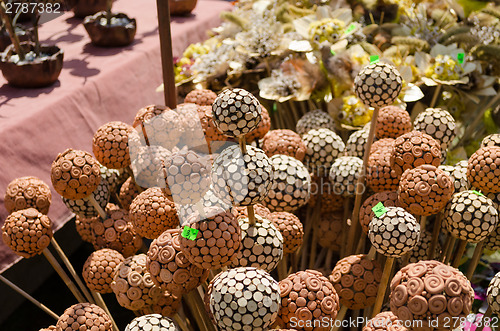 Image of handmade wooden and clay balls ornaments on stick  