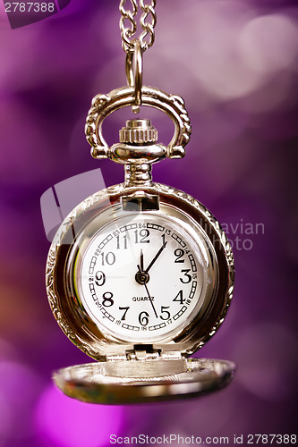 Image of silver retro clock on a festive purple background