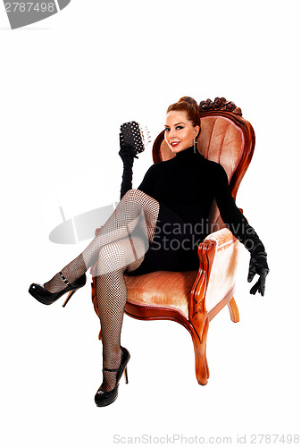 Image of Woman sitting in armchair.