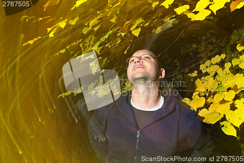 Image of Man enjoys in autumn park