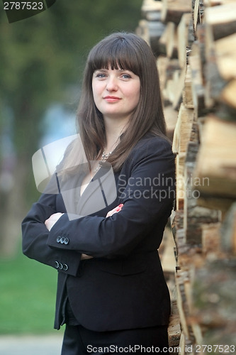 Image of Business woman posing with wood
