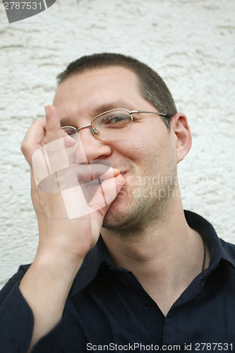 Image of Nicely dressed man simulates cigarette smoking