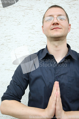 Image of A man in a shirt with a namaste greeting