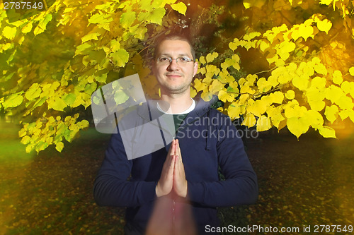 Image of Young man with namaste greeting