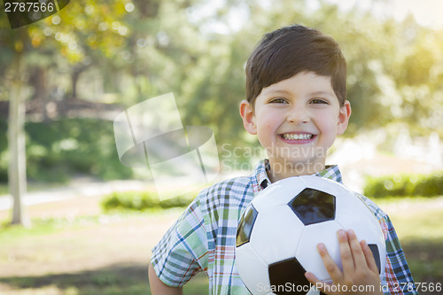 Image of Cute Young Boy Playing with Soccer Ball in Park