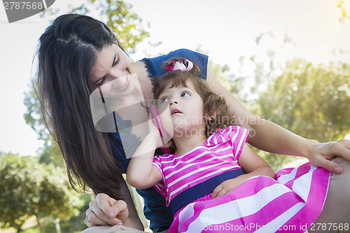 Image of Mother and Cute Baby Daughter Playing with Cell Phone