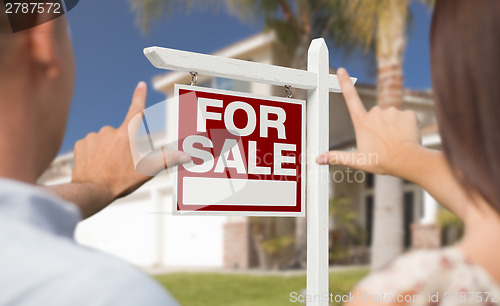 Image of For Sale Sign, House and Military Couple Framing Hands