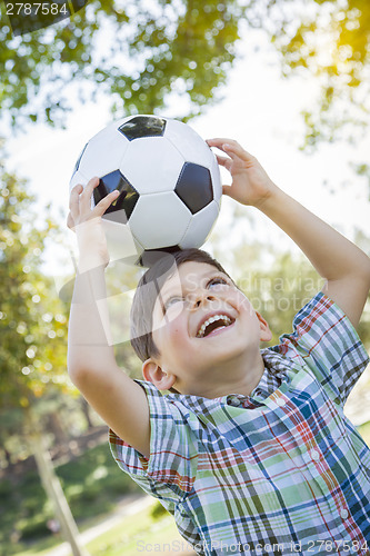 Image of Cute Young Boy Playing with Soccer Ball in Park