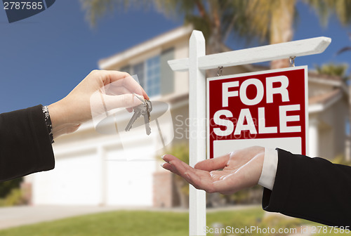 Image of Agent Handing Over House Keys in Front of New Home