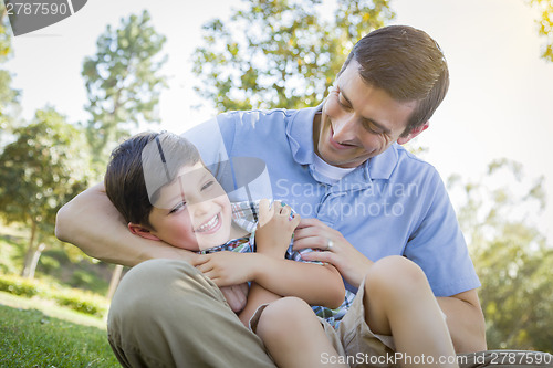 Image of Loving Father Tickling Son in the Park