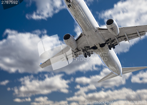 Image of Jet Airplane Landing with Dramatic Clouds Behind
