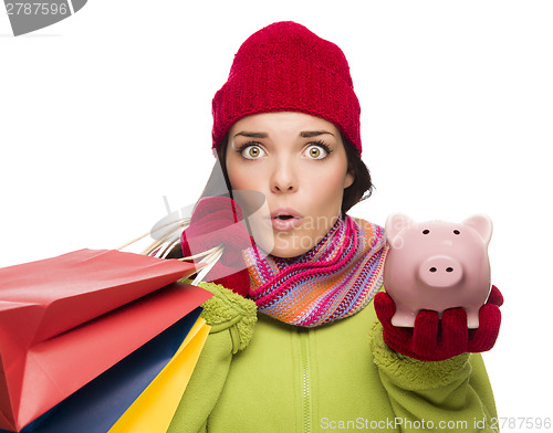 Image of Concerned Mixed Race Woman Holding Shopping Bags and Piggybank