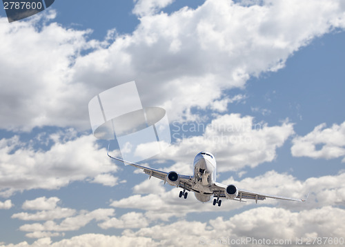 Image of Jet Airplane Landing with Dramatic Clouds Behind