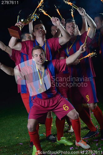 Image of soccer players celebrating victory