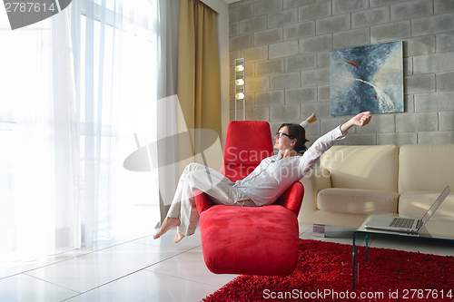 Image of happy young woman relax at home on sofa