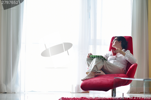 Image of woman using tablet pc at home