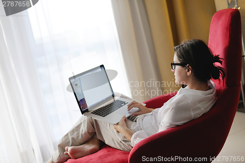 Image of woman using a laptop computer at home