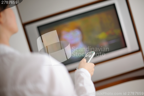 Image of happy young woman relax at home on sofa