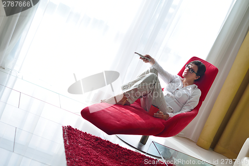 Image of happy young woman relax at home on sofa