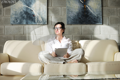 Image of woman using tablet pc at home