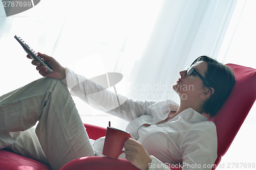 Image of happy young woman relax at home on sofa