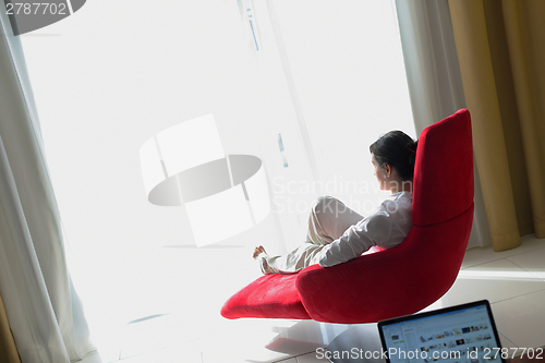 Image of happy young woman relax at home on sofa