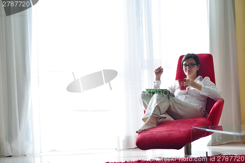 Image of woman using tablet pc at home