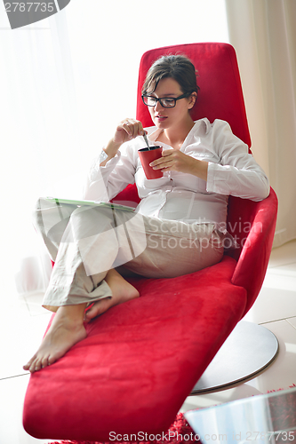 Image of woman using tablet pc at home