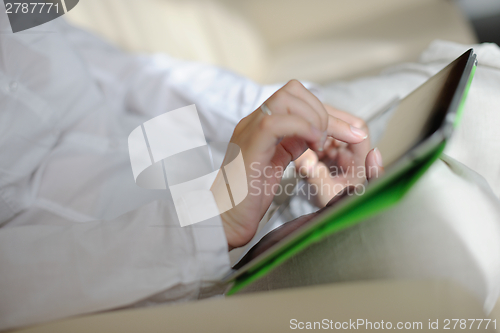 Image of woman using tablet pc at home