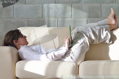Image of woman using tablet pc at home