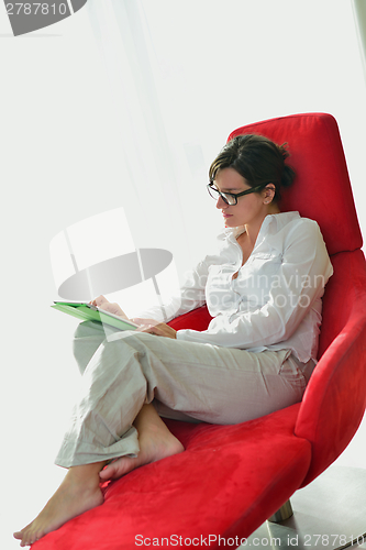 Image of woman using tablet pc at home